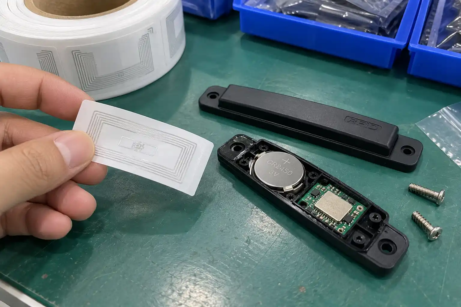 A passive RFID sticker next to a larger active RFID hard tag