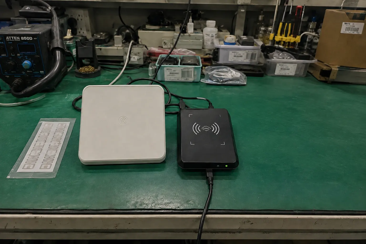An infographic showing the four components of an RFID system: tag, reader, antenna, and software, connected by radio waves.