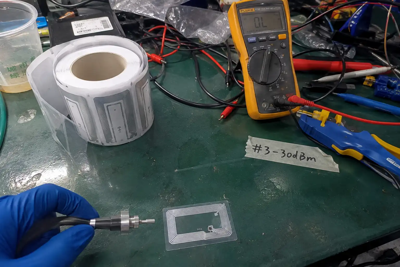 Fongwah engineer testing passive RFID tag IC and antenna power harvesting in a lab setting.