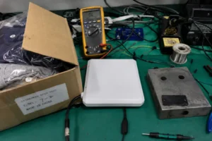 Fongwah RFID reader scanning tagged apparel in a box and industrial components on a workbench.