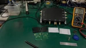 Fongwah engineering site survey setup with handheld readers, spectrum analyzer, and RFID tags on an industrial test bench.