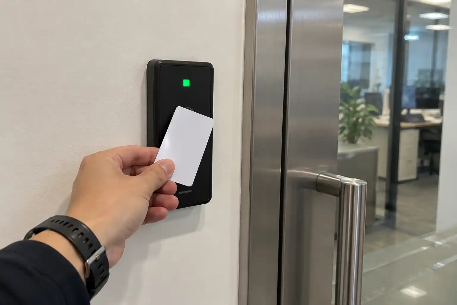 Employee using a secure RFID badge at an office door reader