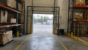 Industrial warehouse loading dock gate with overhead and side-mounted RFID portal frames.