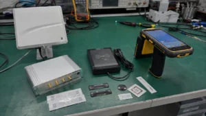 Complete lineup of Fongwah UHF RFID reader writers including USB desktop encoders, fixed portal modules, and industrial handheld terminals on a test bench.