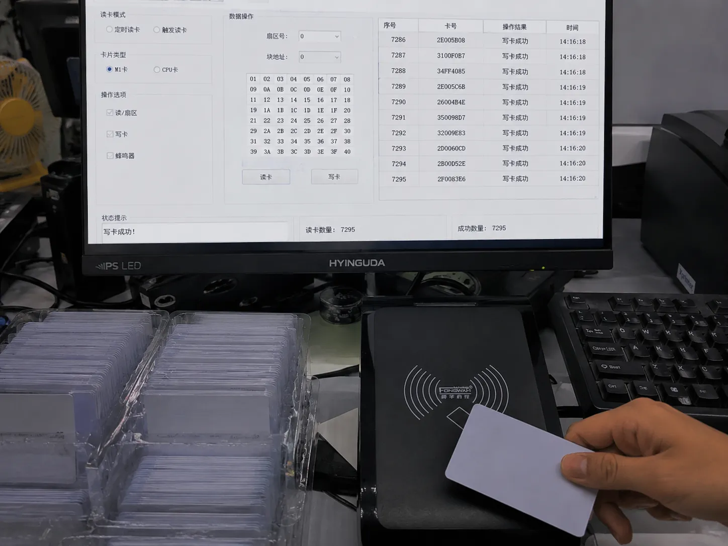 A professional desktop RFID reader flawlessly writing data to a stack of cards
