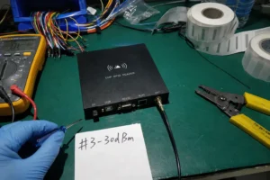 Fongwah B2B industrial RFID reader hardware diagnostics testing on a messy Shenzhen electronics development workbench