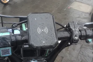 Weatherproof Fongwah HF RFID reader module on shared e-bike handlebar for tap-to-unlock asset access control.