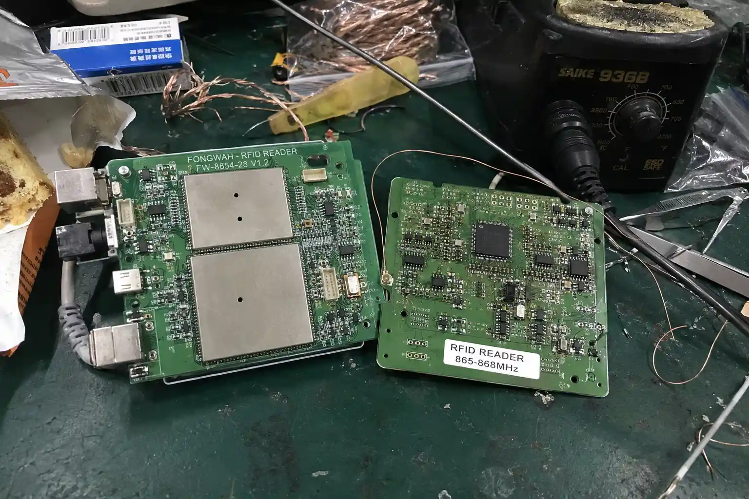 PCB comparison showing a Fongwah reader with EMI shielding cans vs. a cheap, unshielded competitor's PCB