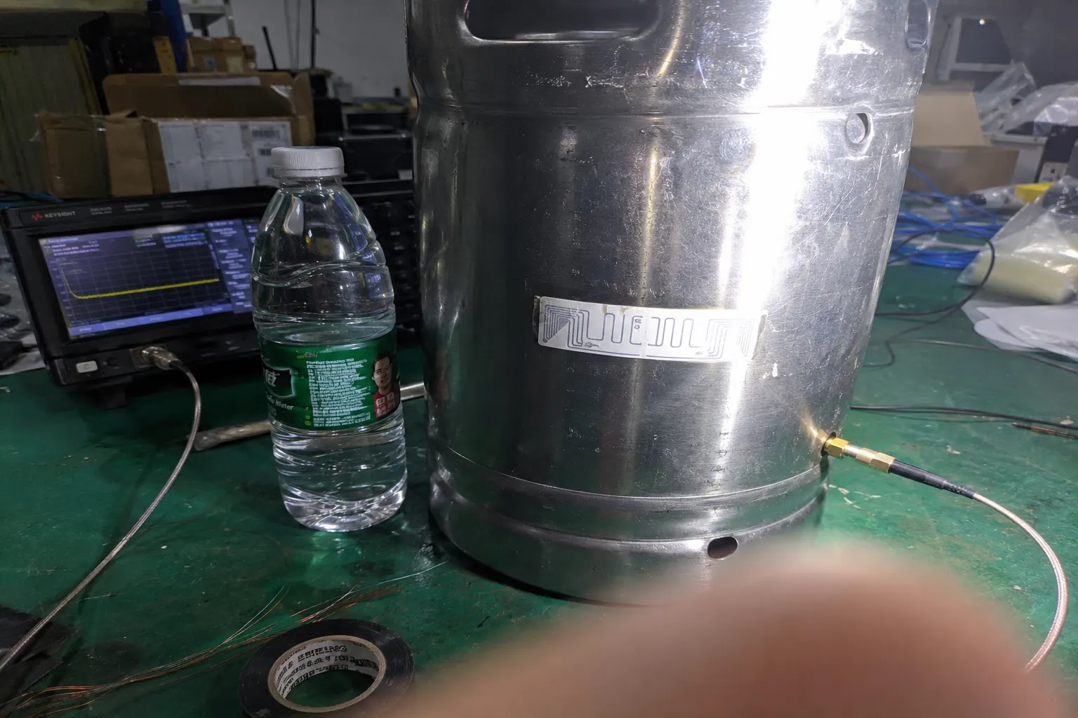 Visual showing how RF waves are absorbed by liquid and detuned by metal, contrasted with a specialized on-metal tag design.