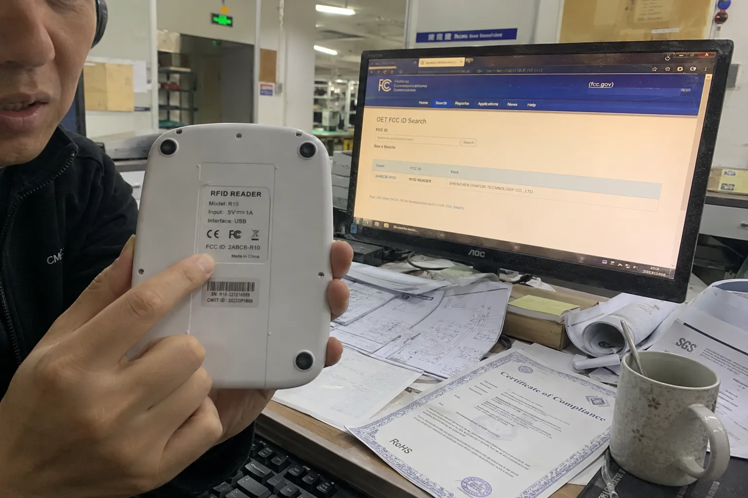 A technician verifying an RFID reader's certification documents and cross-referencing the FCC ID in an online database