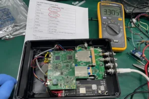 Fongwah multi-region UHF RFID reader module undergoing regional frequency band testing on a messy Shenzhen lab workbench